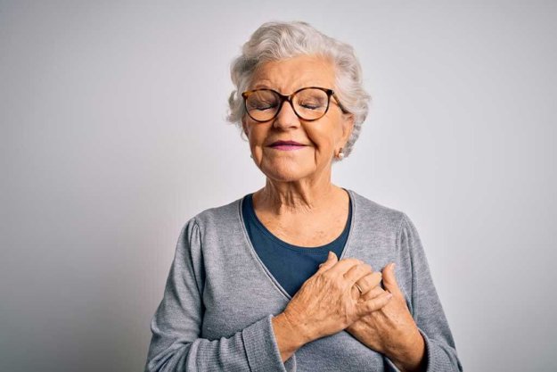 Senior beautiful grey-haired woman wearing casual sweater and glasses