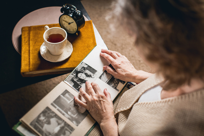 an elderly woman looks at your picture in the album made many ye How Photography Can Help Individuals With Alzheimer's Disease