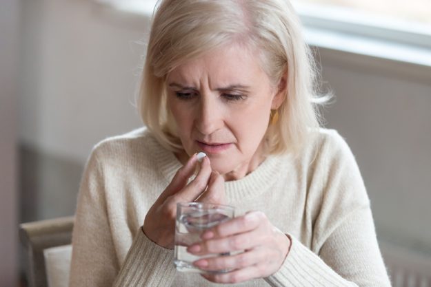 Senior unwell woman unsure about taking medicines at home What If You Don't Get The Right Treatment For Dementia?
