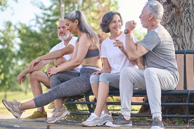 Mid aged people resting in the park after the workout