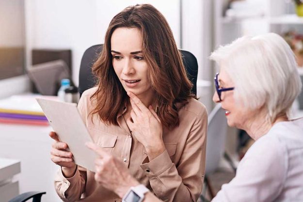 Attentive businesswomen sharing ideas in the office Attentive businesswomen sharing ideas in the office