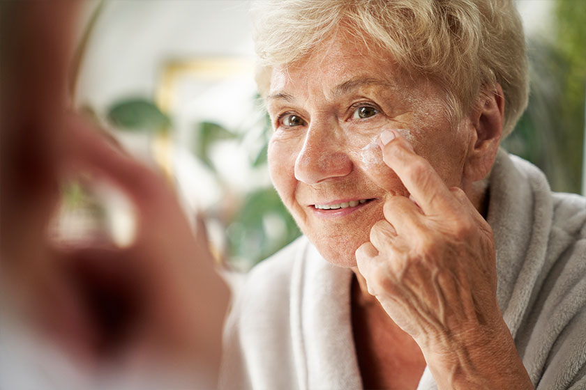 Senior woman applying a face cream