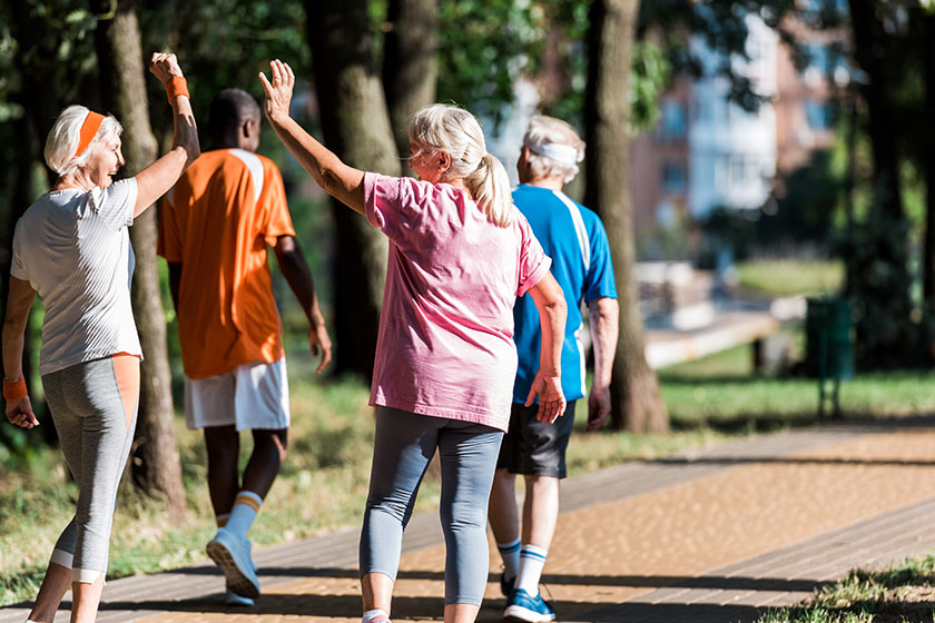 Selective focus of senior women gesturing near multicultural retired men