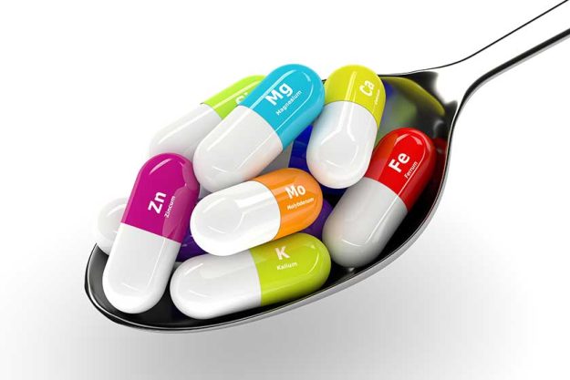 3d rendering of dietary supplements on spoon isolated over white 3d rendering of dietary supplements on spoon isolated over white