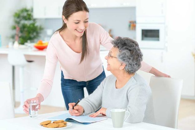Carer helping woman at home