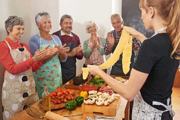Cooking-pasta-and-chef-with-people-in-kitchen-learning