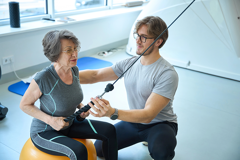 young-specialist-advises-patient-gym