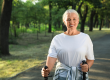Mature woman with walking poles in park